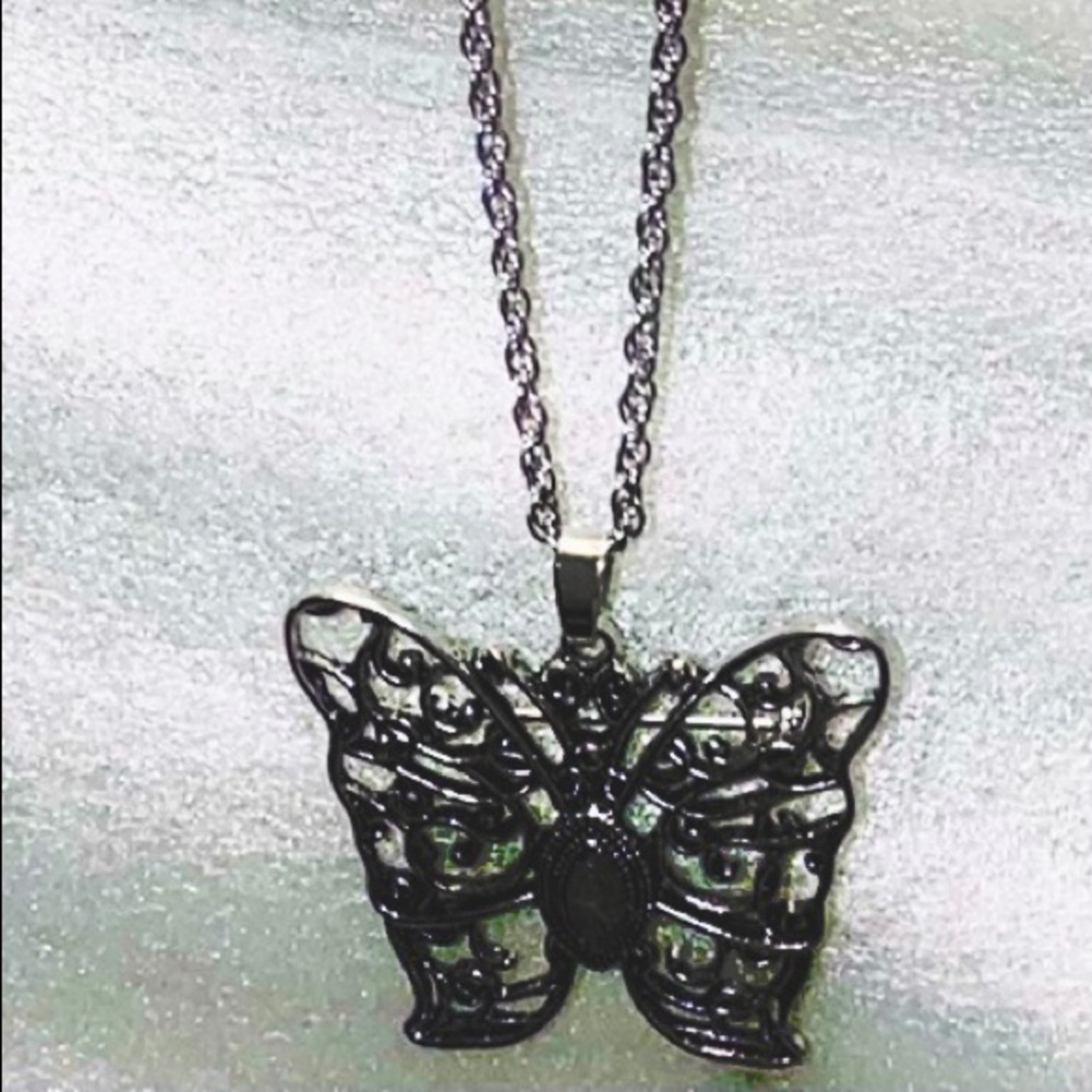 Butterfly necklace with purple stone in center